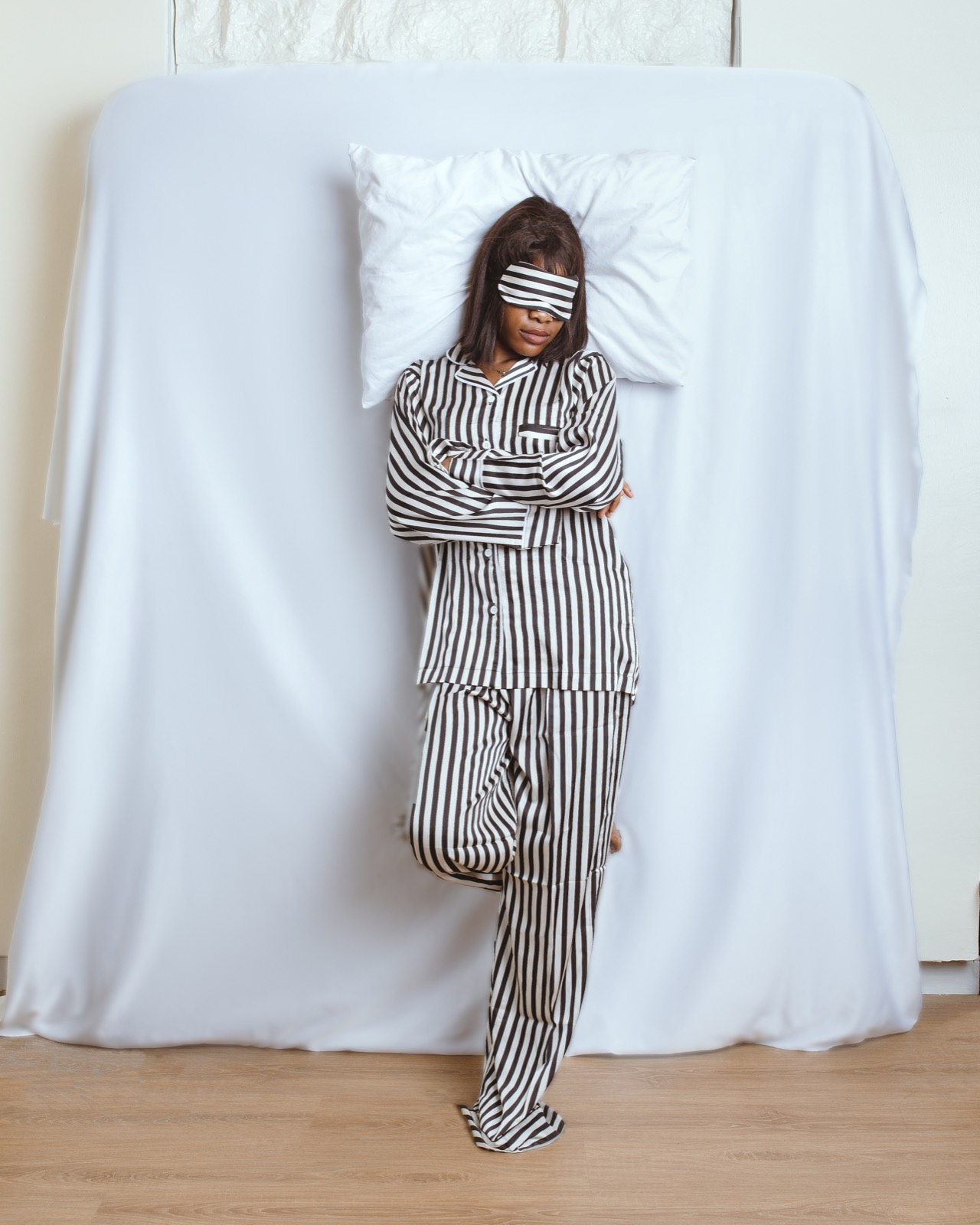 Woman in a black and white striped set with a matching sleep mask